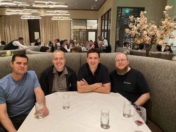 Vonage developer team members sitting together at a dinner table during API World Hackathon 2025