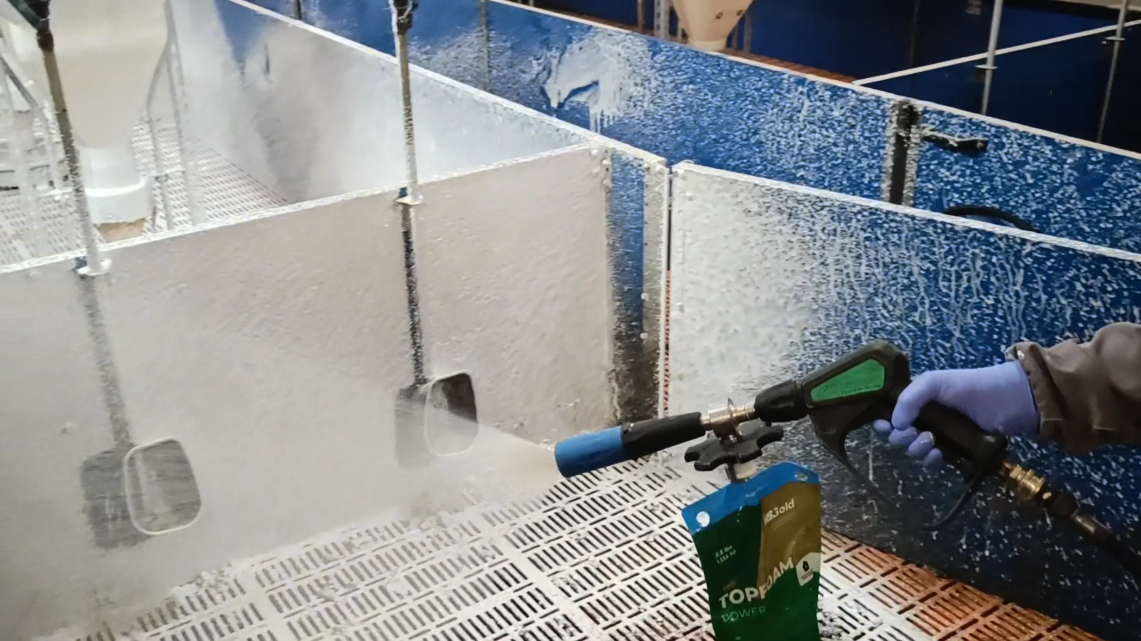 Person using a pressure washer to clean a tiled floor, with a hybag topfoam power
