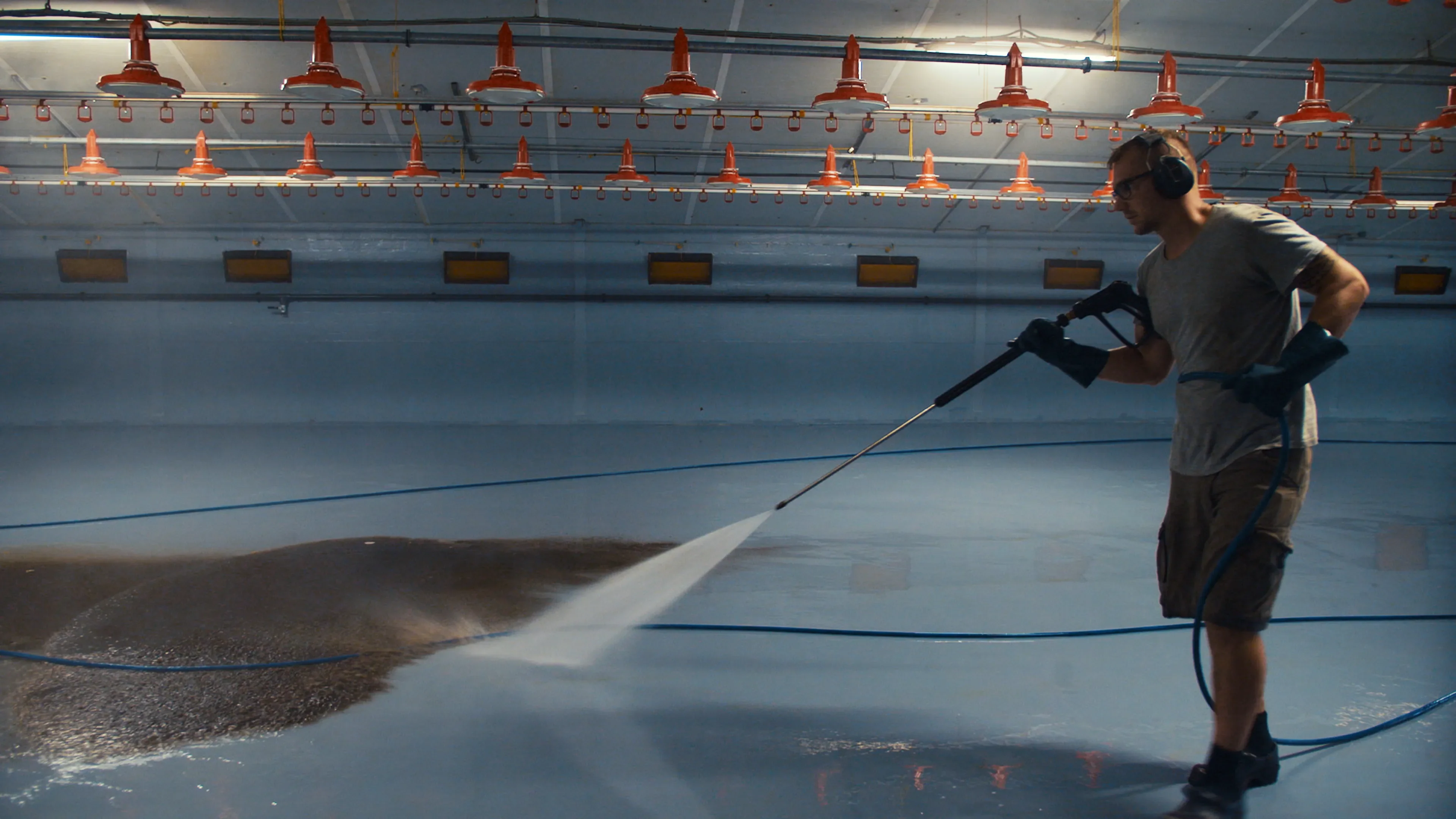 Rinsing the poultry barn with a high pressure washer after cleaning with MS TopFoam