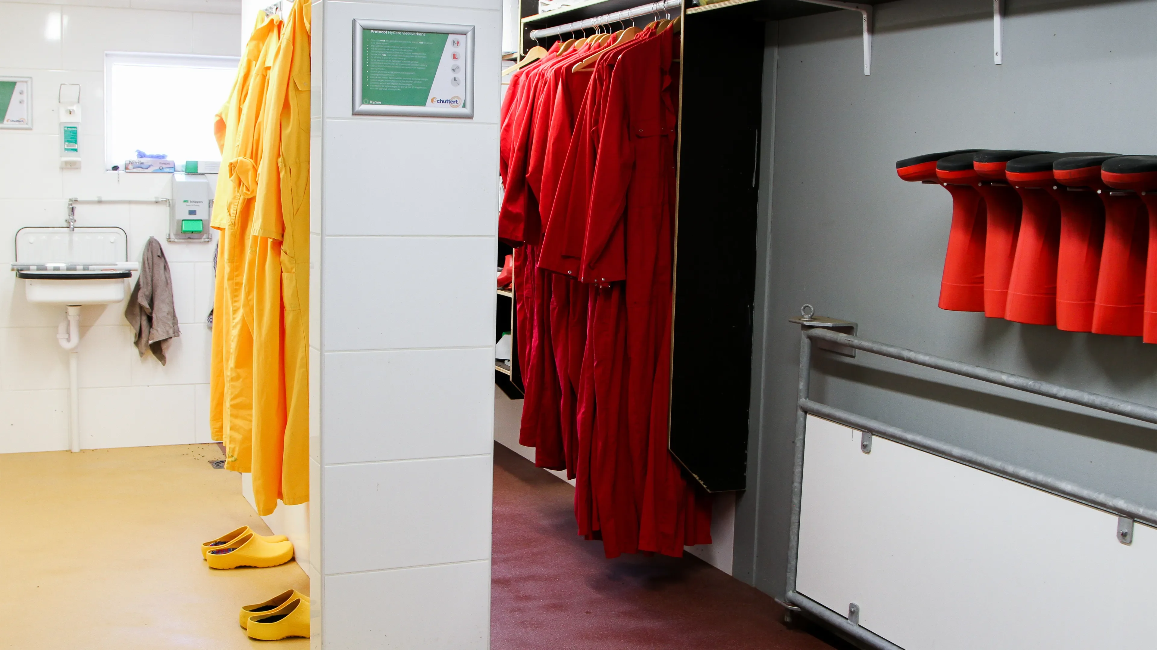Locker room with Yellow and red overalls and boots