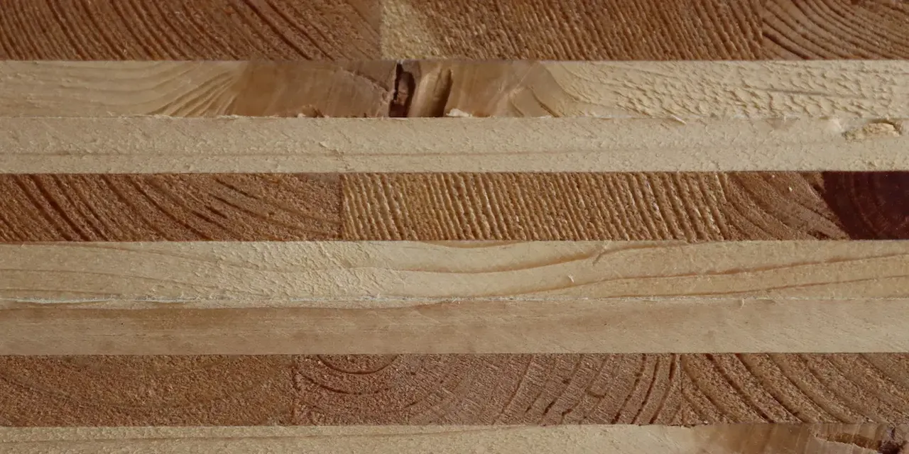 Nahaufnahme von dicken Holzplatten mit guter Sichtbarkeit der drei verleimten Holzschichten für höchste Formstabilität und kaum Rissbildungen.