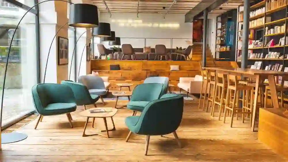 Gemütliche Lounge mit stilvollen Sesseln und Bücherwand – ein Ort zum Verweilen, Arbeiten und Begegnen.