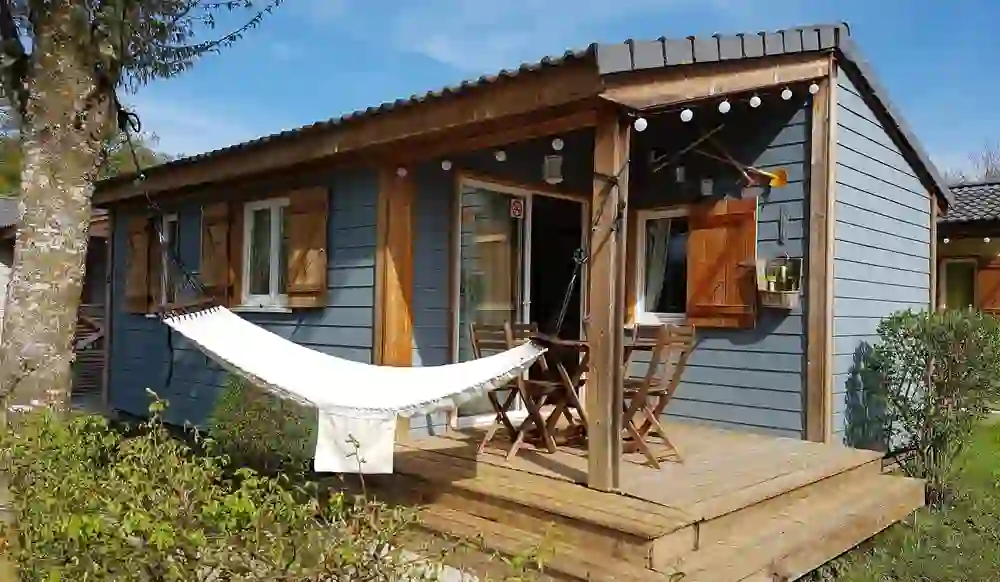 A cosy bungalow at TCS Camping Eymatt with veranda and hammock invites you to relax in green surroundings and radiates an atmosphere of peace and holiday.