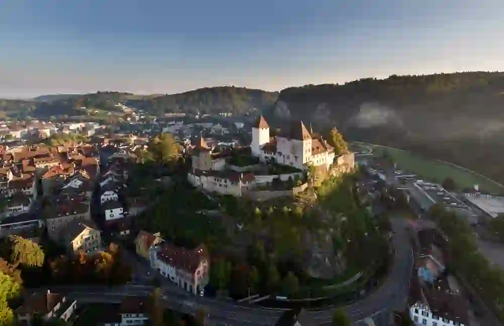 Burgdorf Castle rises gracefully above the town, nestled in the twilight, and conveys a sense of historical dignity and quiet vigilance.