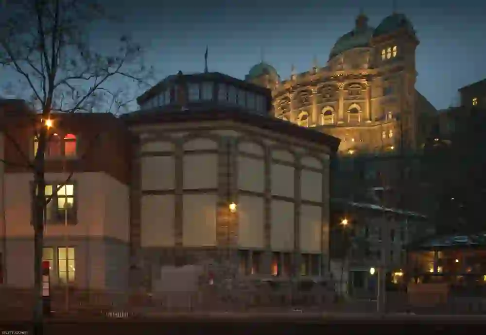 The exterior view of the Hammam & Spa Oktogon in Bern shows an atmospherically illuminated building at the blue hour, whose warm light conjures up an inviting atmosphere in the evening scenery.