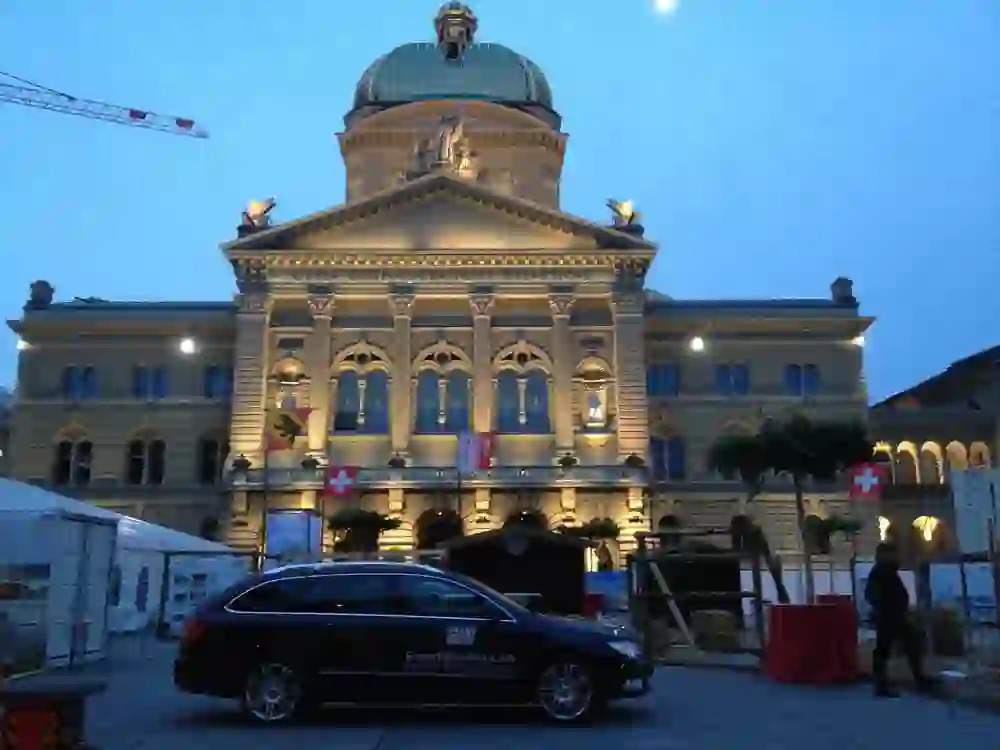 Festively lit Federal Palace, framed by an event set-up and security presence. The atmosphere is calm but organised - everything is ready for the upcoming event.