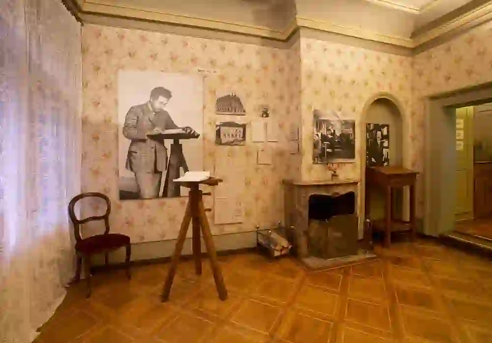 The picture shows a room with historical flair, decorated with a large photo of Albert Einstein and exhibits. The mood is thoughtful and educational.