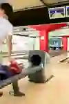 A young player at the Marzili Bowling Centre concentrates on his ball, ready for his next throw, while the game is in full swing in the background.