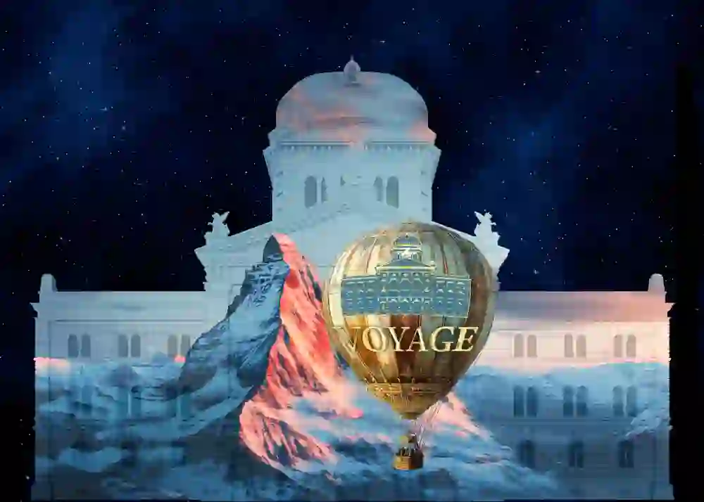 L'image montre une visualisation du Palais fédéral avec la projection du spectacle lumineux de cette année sur le thème "Voyage", au cours duquel le Palais fédéral se transforme en un écran impressionnant.