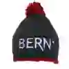 The picture shows the knitted hat BERN with a red knitted button at the top and border at the bottom