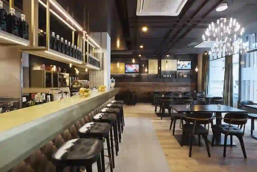 The picture shows a stylish bar at The Bristol with elegant lighting and chic bar stools that create an appealing and sociable atmosphere.