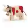 The picture shows a wooden cow with a bell and red spots from the Trauffer Spielwaren brand