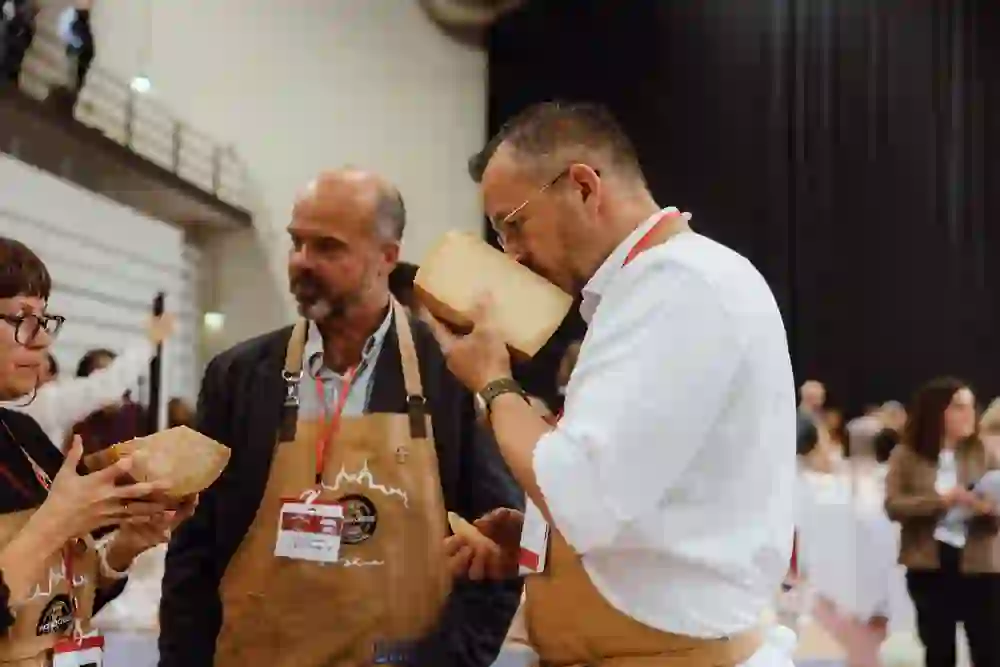 The picture shows two people tasting cheese at the World Cheese Awards