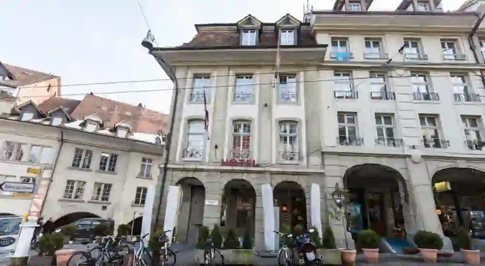 The photo shows the façade of the traditional Hotel Nydeck in the lively Bernese street scene, which conveys a historic and inviting urban atmosphere.