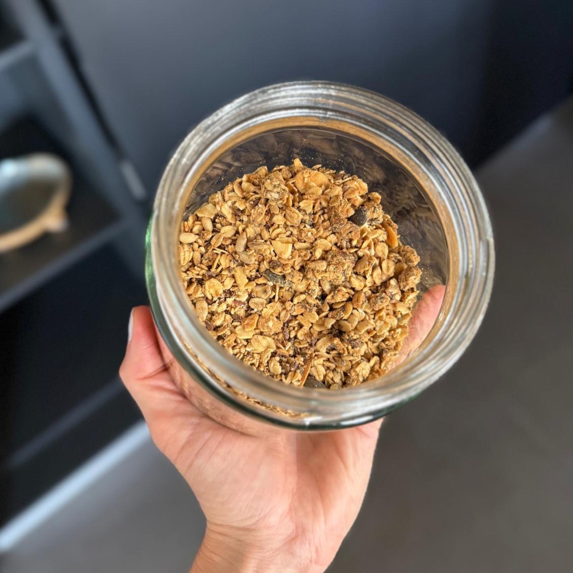 High-protein gestational diabetes breakfast photo of homemade peanut butter seed granola in a glass jar.