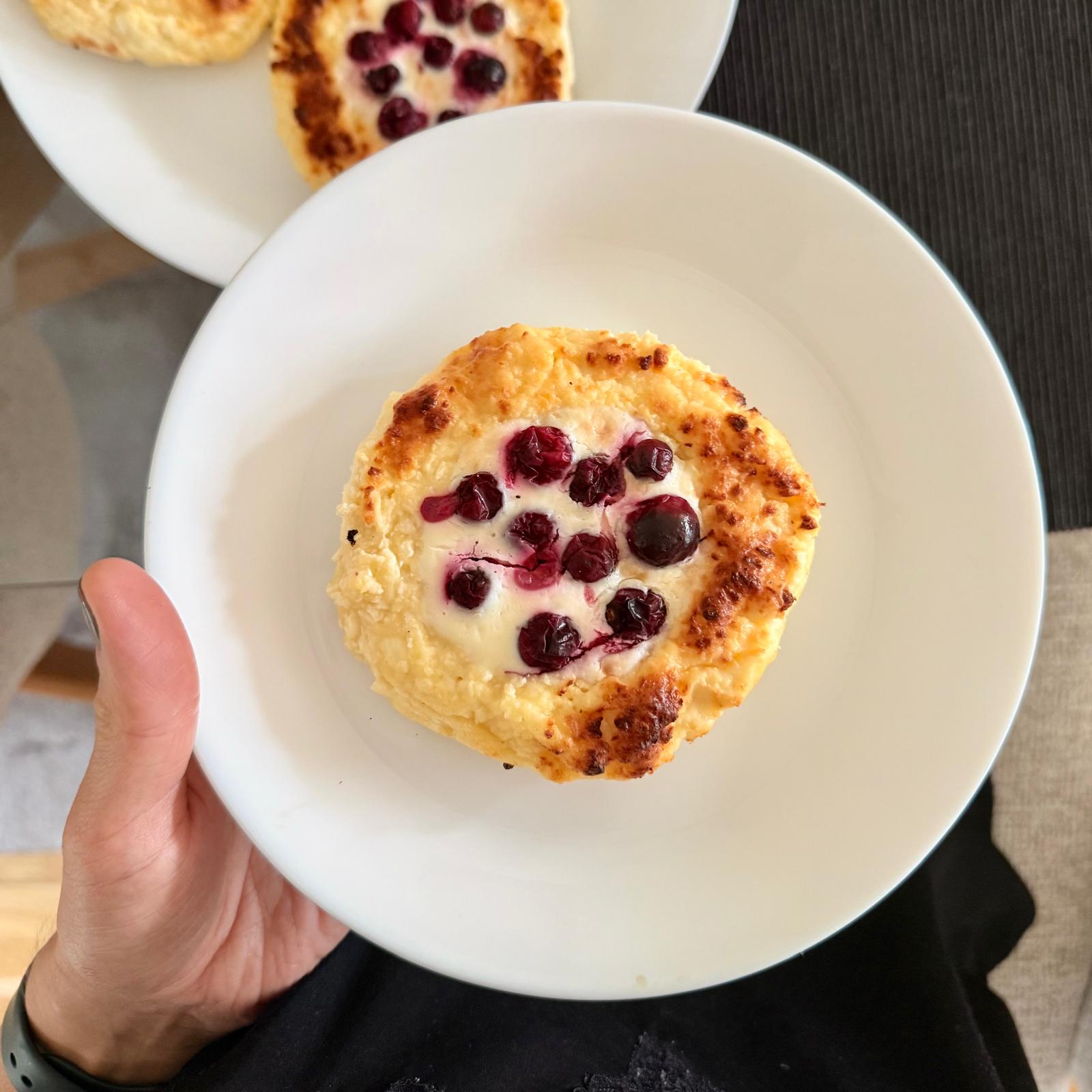 High-protein gestational diabetes breakfast photo of berry cheesecake bites topped with berries on a white plate.