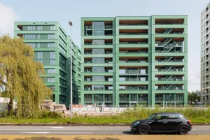 Individuell entworfene vorgefertigte grüne Putzelemente prägen die Fassaden durch feine, nahezu nahtlose Farbverläufe