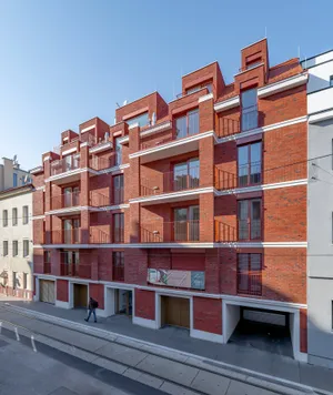 „House of Bricks" residential building in Vienna with red brick facade and balconies