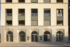 Multi-storey parking structure next to a modern residential and office building.