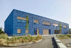 Modern building complex featuring an artistically designed blue façade.