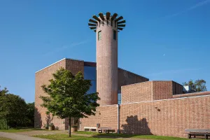 Renovated bell tower of Nørre Uttrup Kirke featuring a custom Sto solution that preserves its shape and protects against moisture.