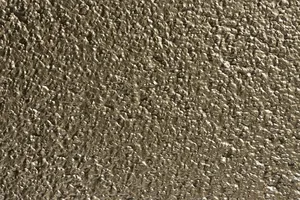 Putz Fassade Putzoberfläche Oberfläche Detail Vollabrieb Kratzputz Scheibenputz 6mm Körnung StoColor Sto Architectural Colours Farbton 163M-Brass Messing glänzend metallisch rau