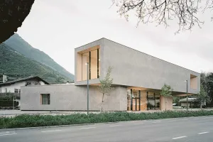 Modern visitor center with a mineral facade blending into the mountain landscape.