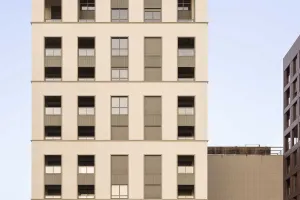 Multi-storey parking structure next to a modern residential and office building.
