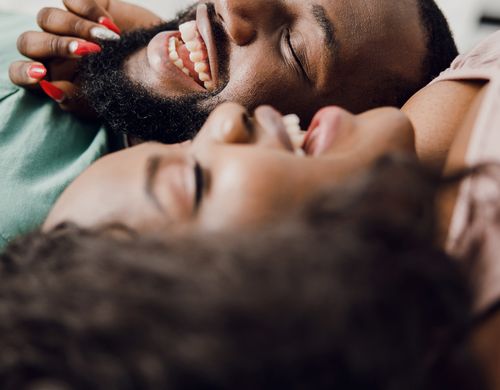 Close-up of a smiling couple lying down together