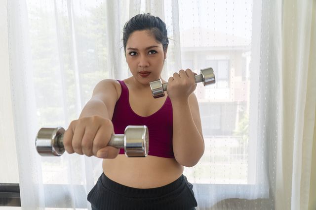 woman working out with dumbbells
