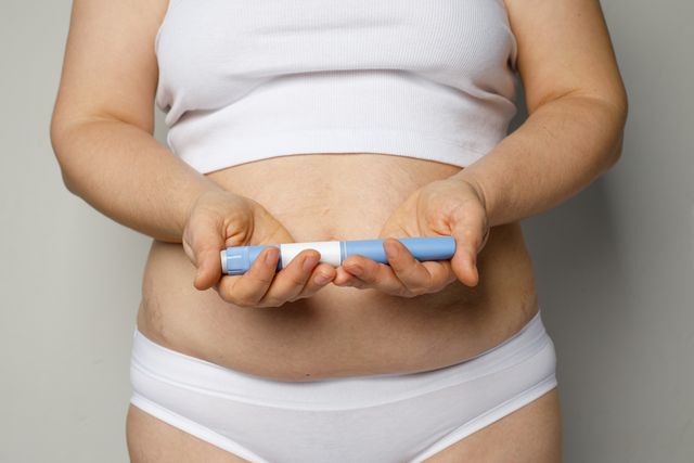 Woman holding Wegovy pen