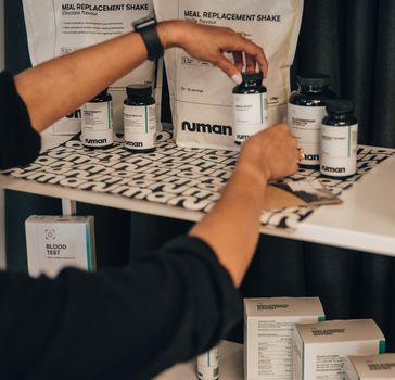 Woman holding Numan supplement on a shelf with Numan products