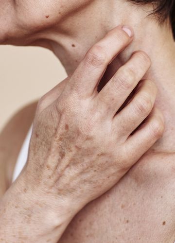 Woman touching neck