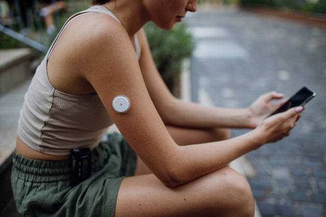 woman with blood sugar monitor