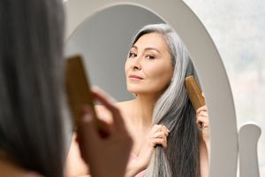 woman menopause doing her hair woman menopause doing her hair