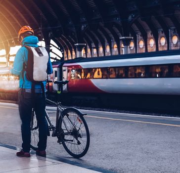 man with bicycle in a train station