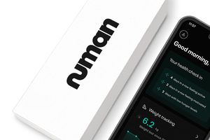 A Numan package next to a smartphone showing the home screen of the  Numan app