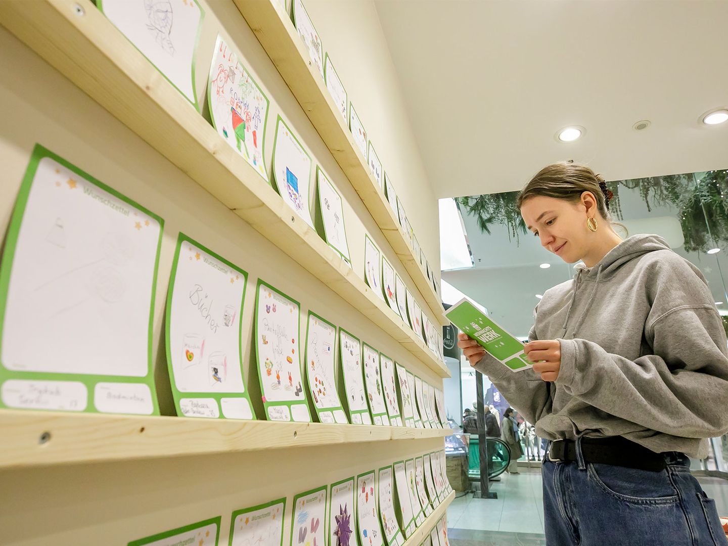 Eine junge Dame vor den Wunschzetteln im Pop Up Store Ulrik Eichentopf