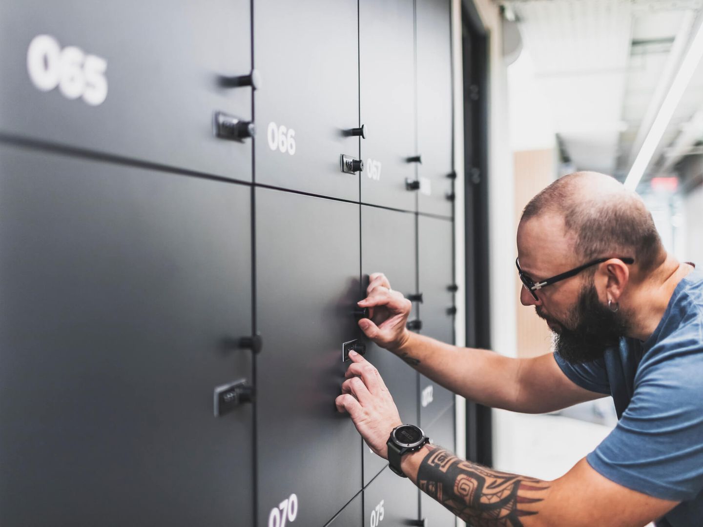 Erwachsener Mann, der sein Schließfach beim modernen Coworking öffnet.  © JulPo / iStock / Getty Images Plus via Getty Images