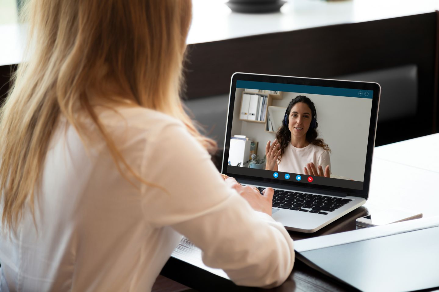 Bewerberin führt über einen Laptop ein Videogespräch mit einer Gesprächspartneri