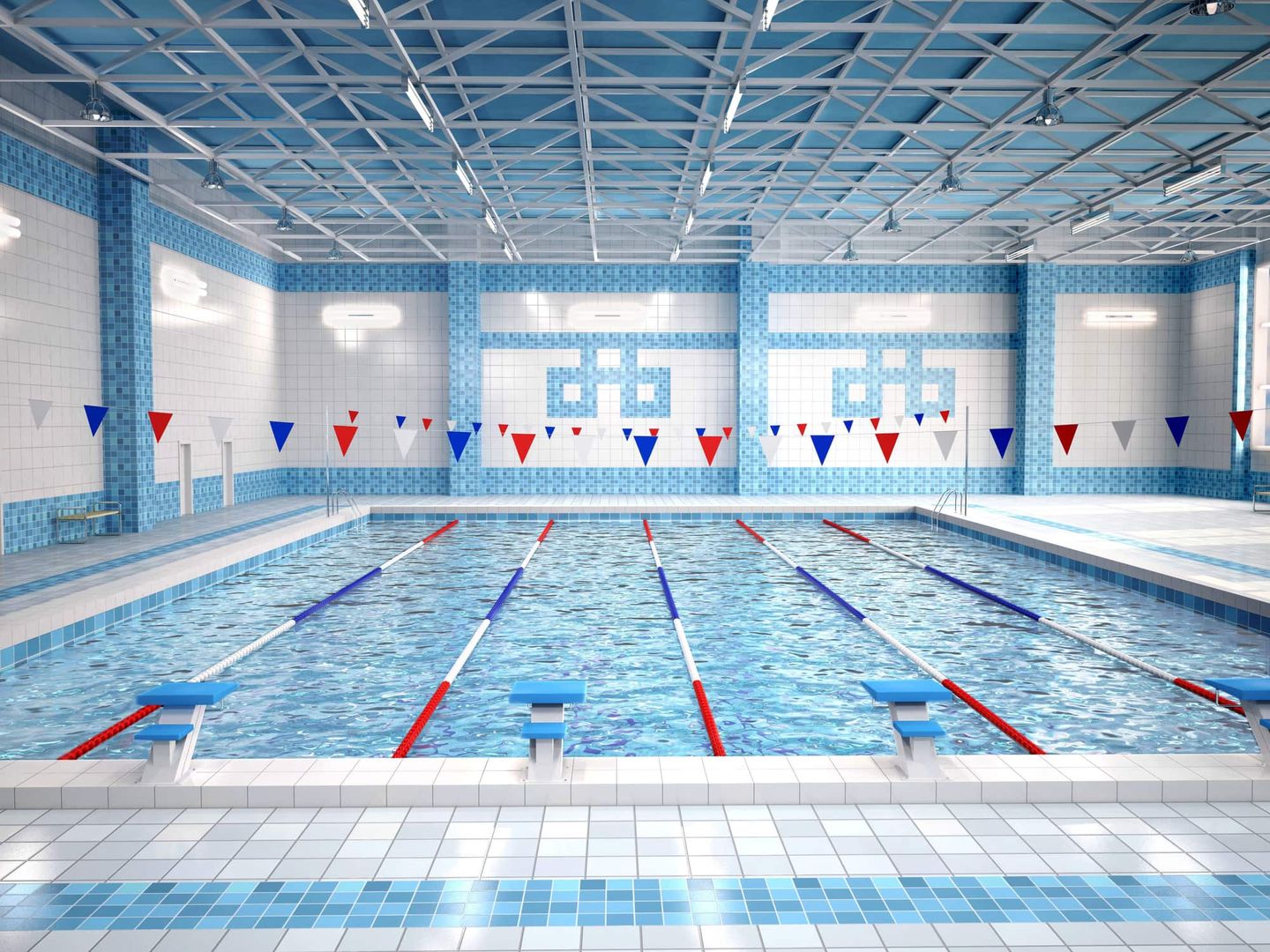 Hallenbad mit Schwimmbahnen und Startblöcken Getty