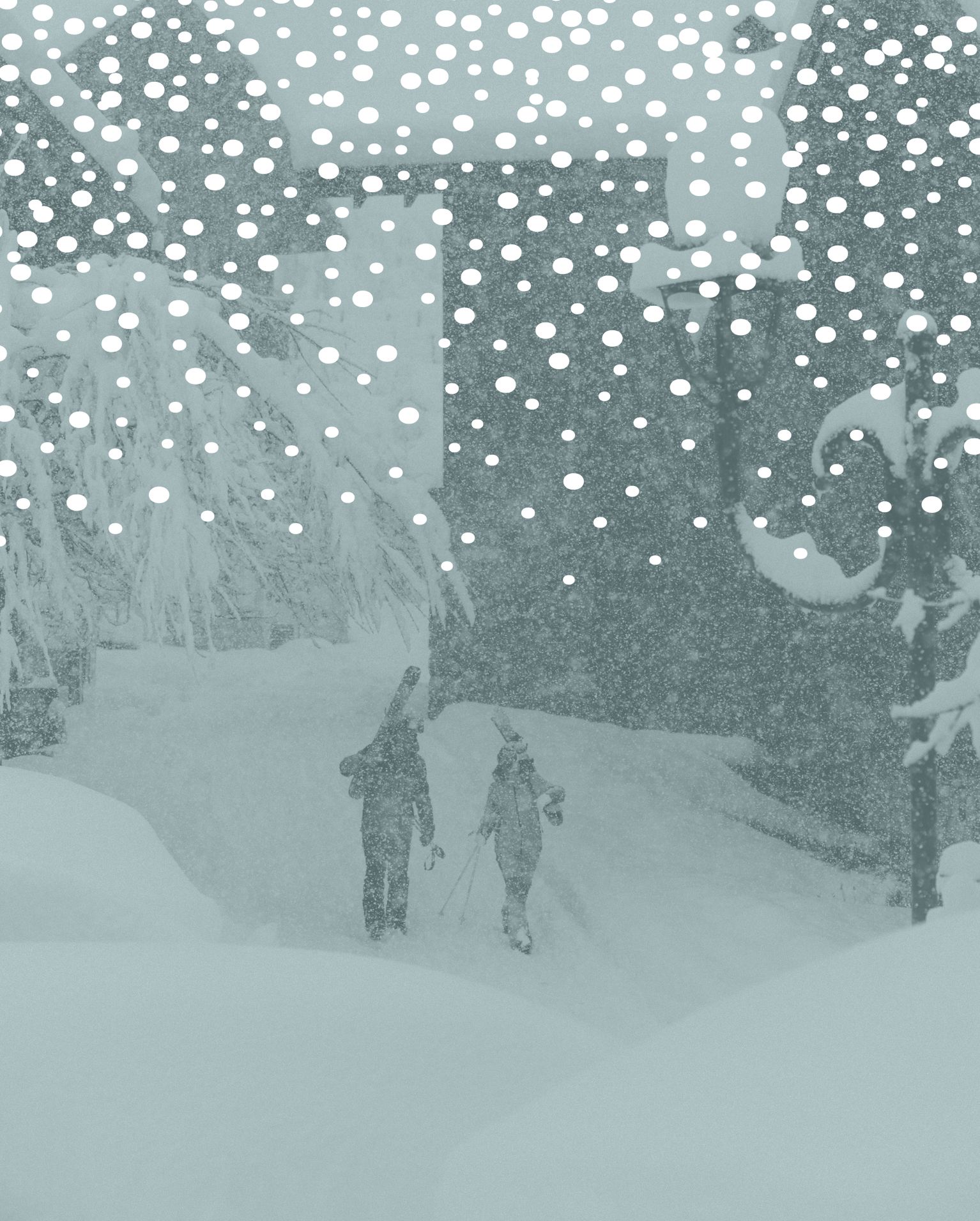 Two people walking through heavy snowfall in a snowy landscape, carrying ski poles, with snow-covered trees and buildings in the background.