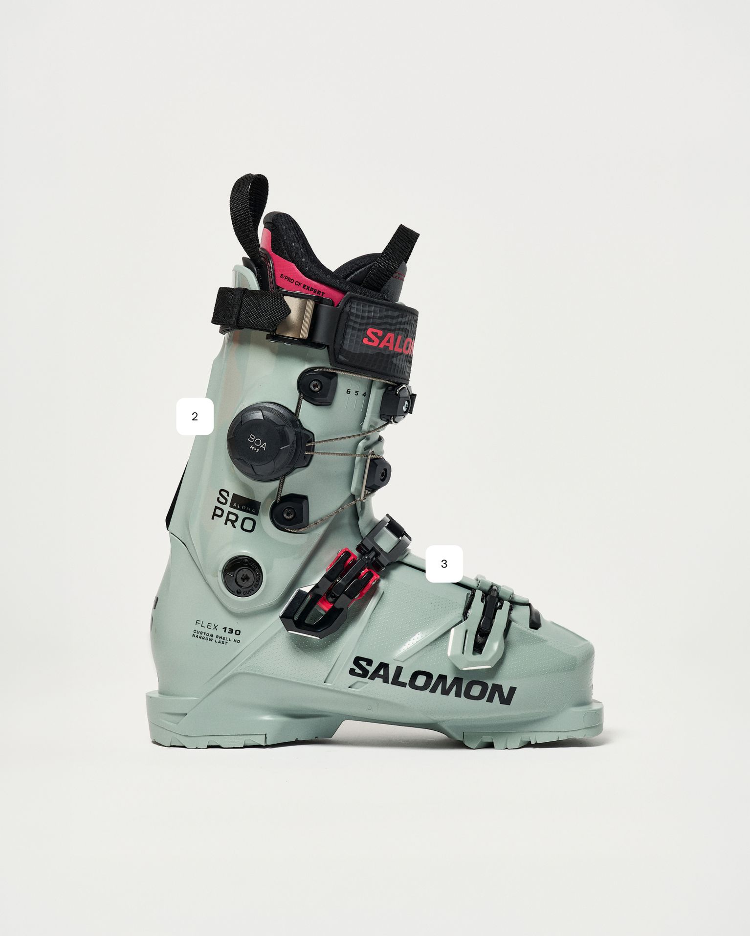 Grey Salomon S/Pro ski boot with black buckles and red accents, featuring customisable fit adjustments.