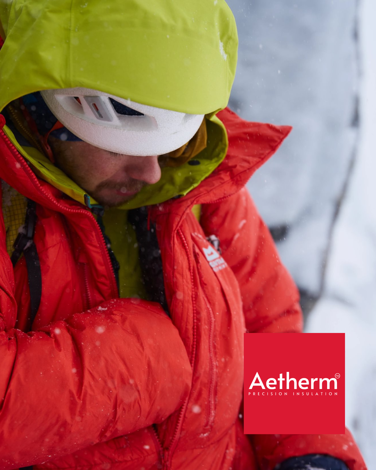 Climber in a Mountain Equipment Super Oreus Jacket warms his hands