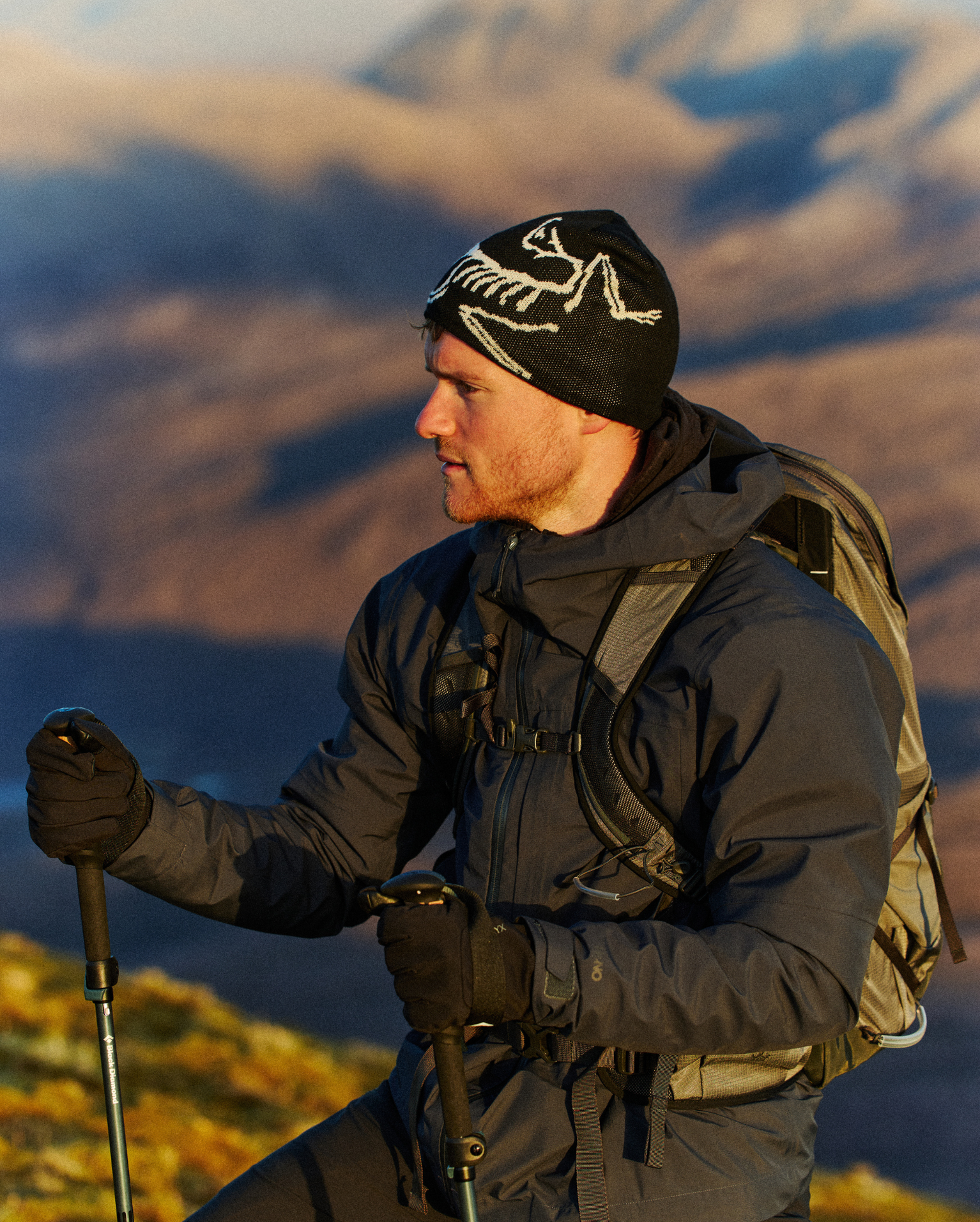 Hiker with an Osprey backpack pauses on the way up a mountain