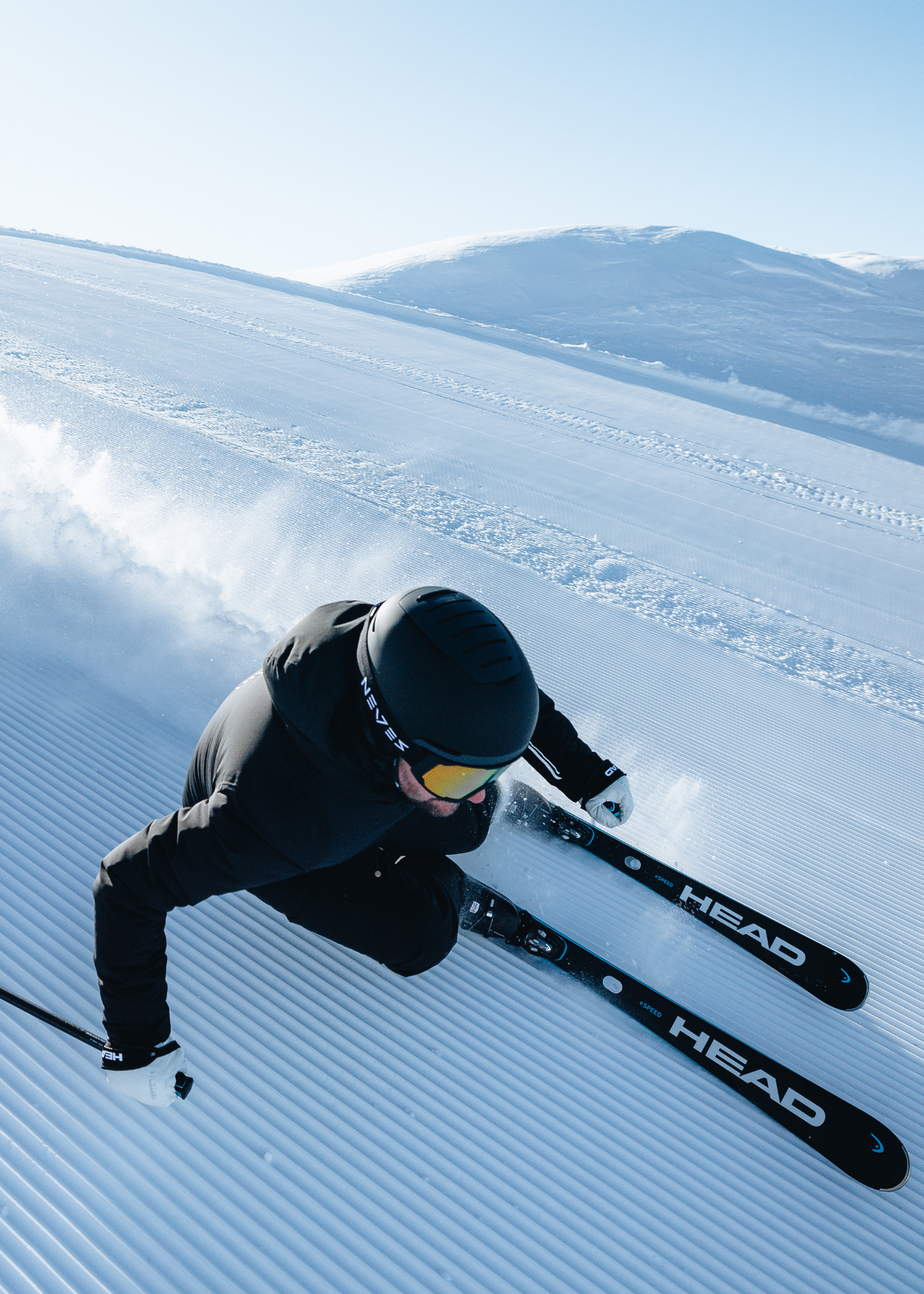 Male downhill skier on groomed piste