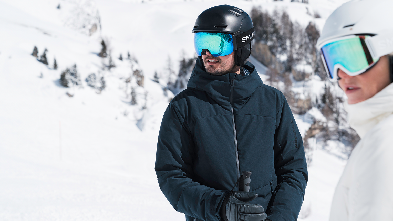 two skiers wearing ski helmets