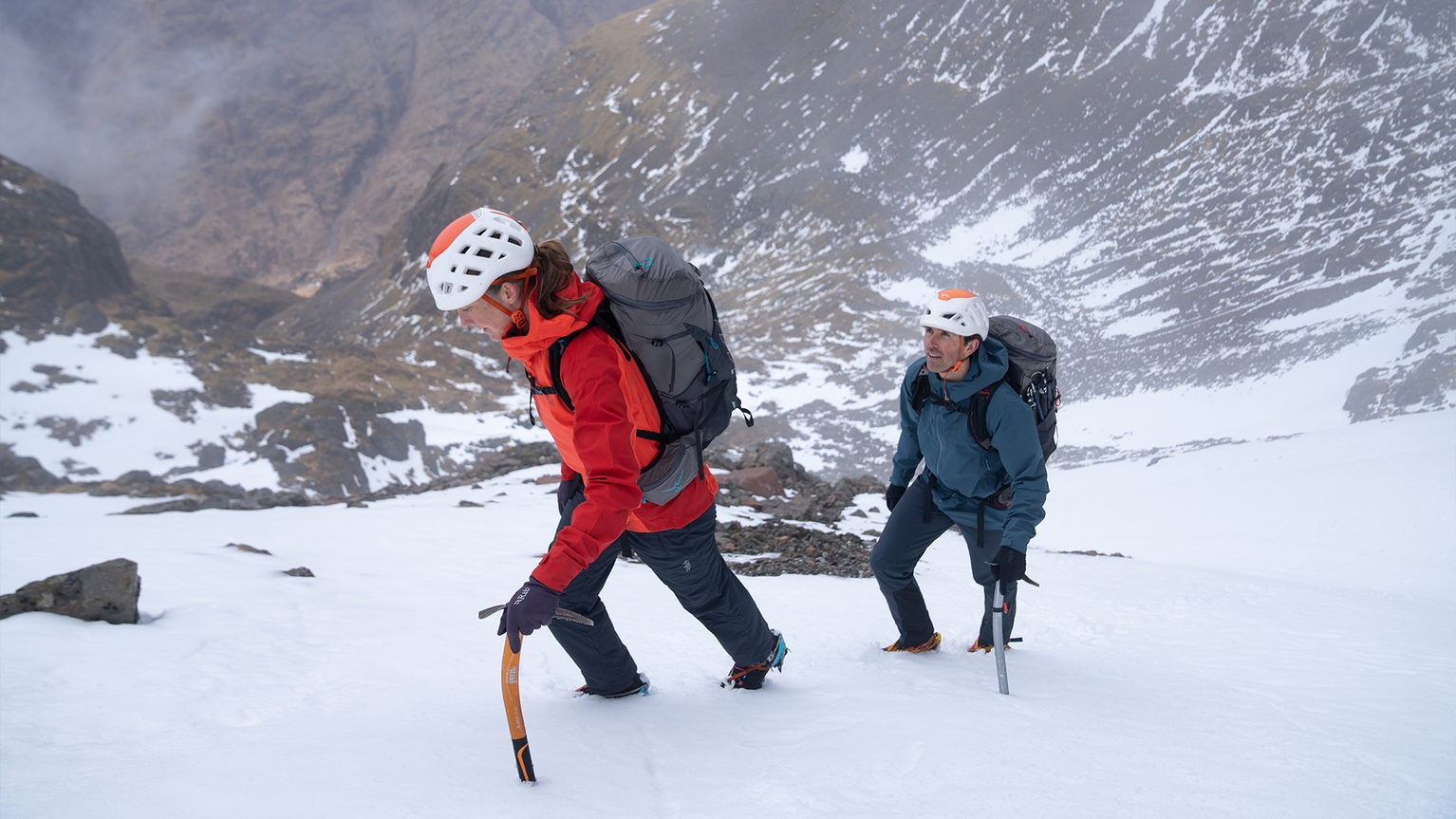 two people walking in snow