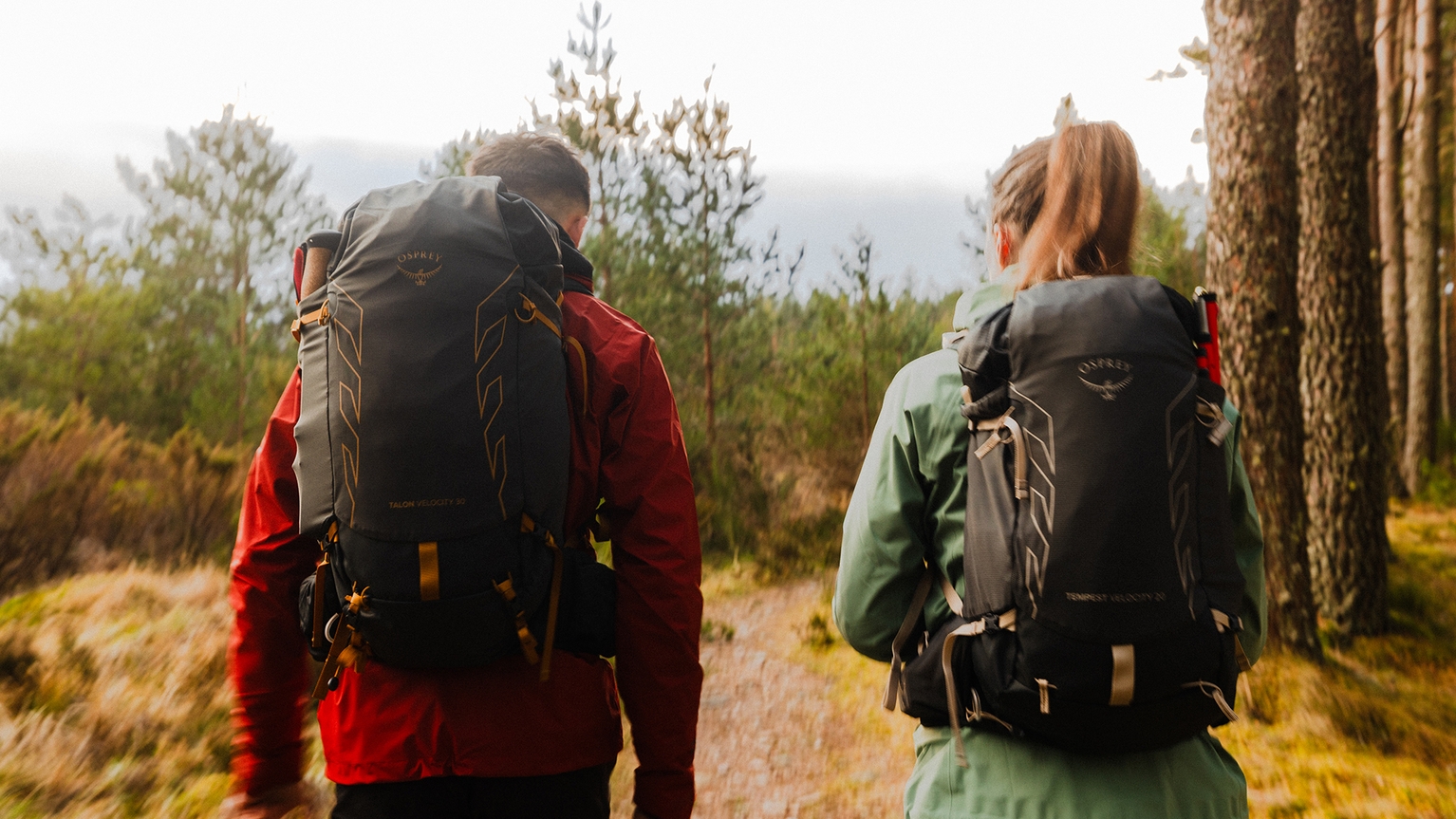 two people wearing osprey backpacks