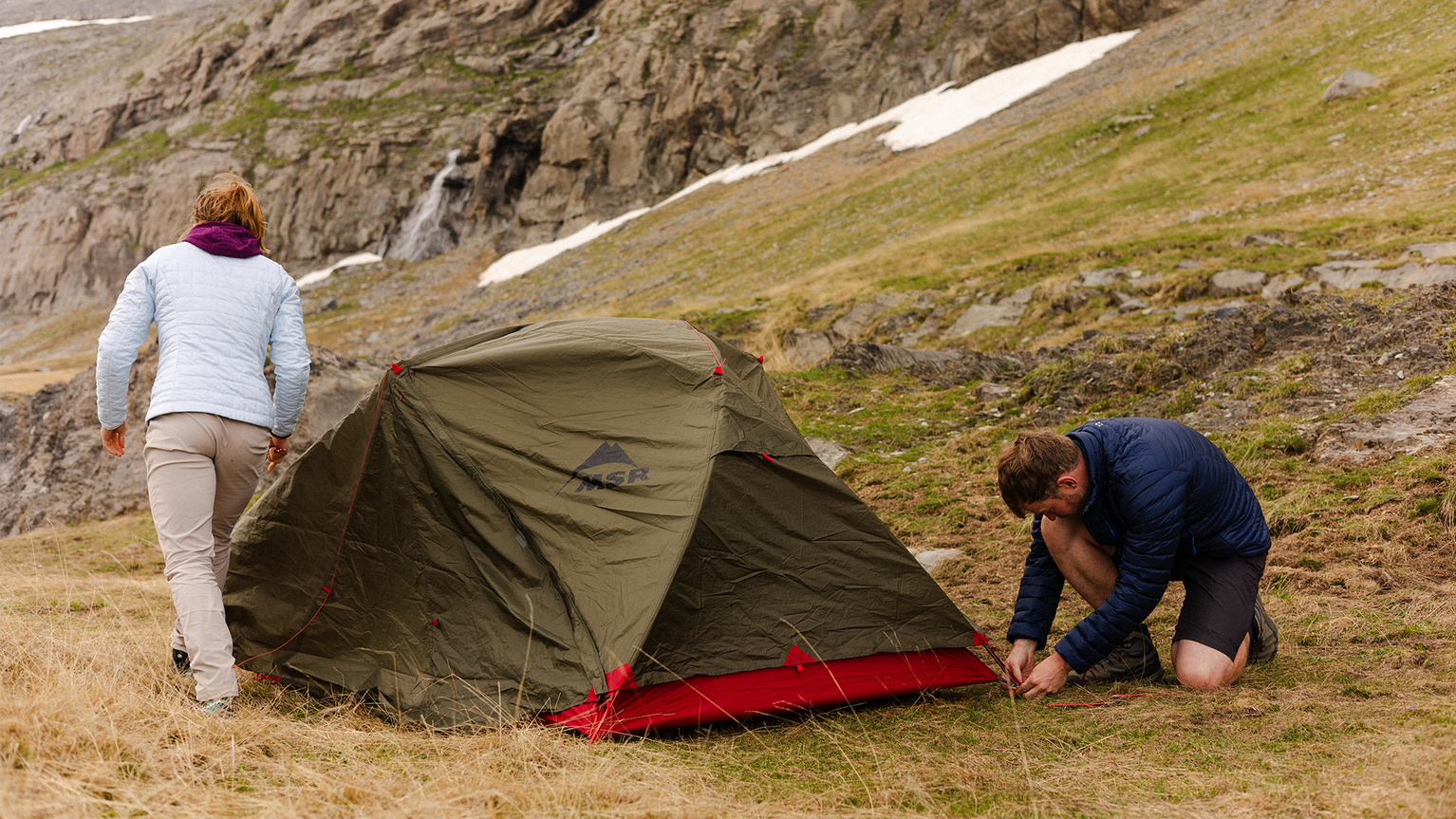 woman standing next to a tent